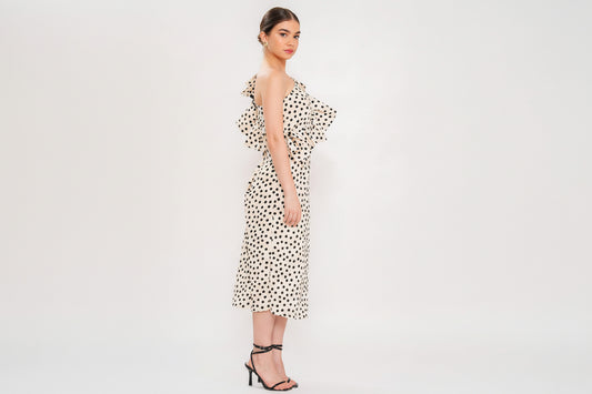 Woman wearing a polka dot dress on a white background