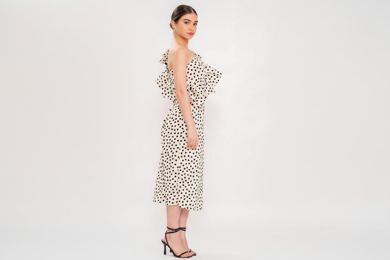Woman wearing a polka dot dress on a white background